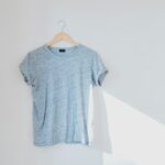 hanged grey shirt on white wall