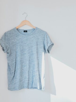 hanged grey shirt on white wall