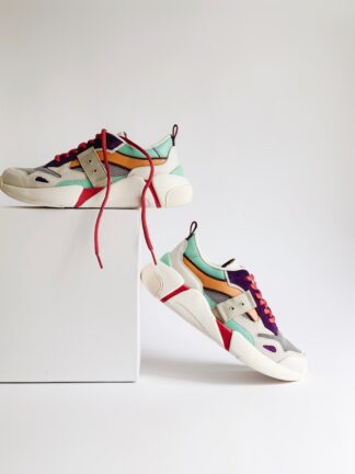 pair of white-and-orange athletic shoes on white box