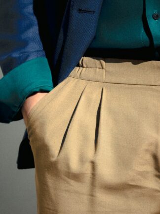 person in blue long sleeve shirt and beige skirt